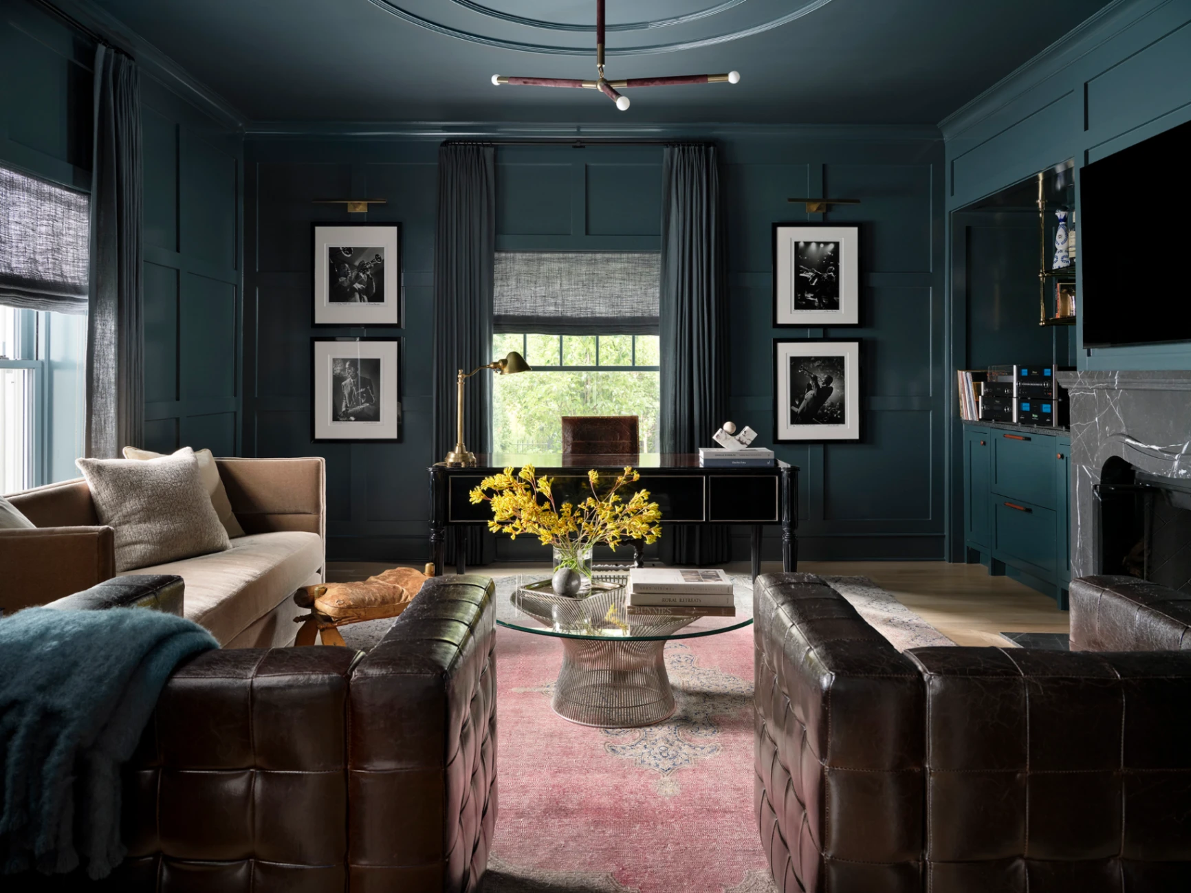 Custom floor-to-ceiling drapery in a designer home office with dark moody paneled walls