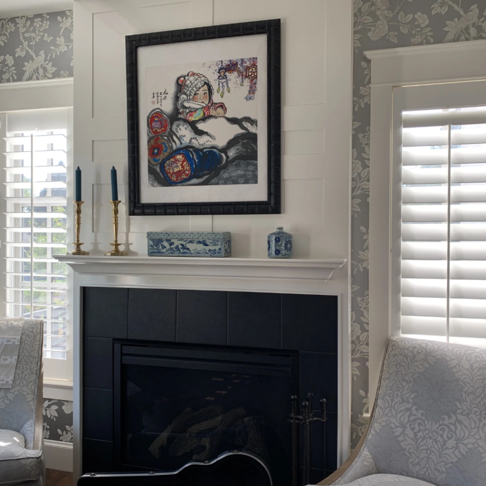 Full-height white plantation shutters in a sophisticated traditional living room with floral wallpaper