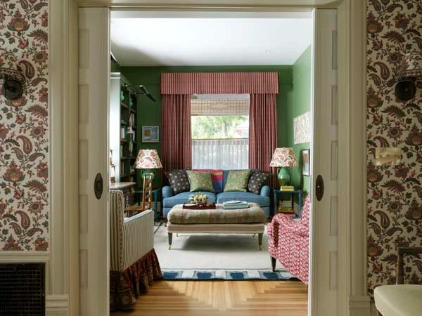 Custom cornice valance and striped drapery panels in a colorful, pattern-rich living room