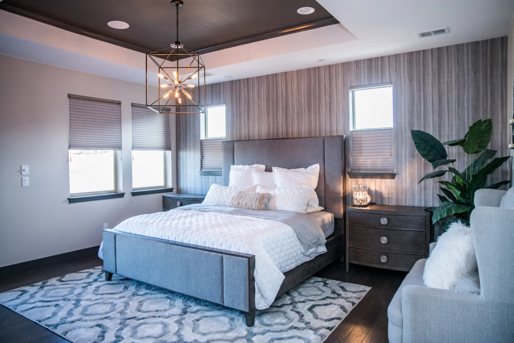 Tailored greige cellular shades providing soft light control throughout a sleek contemporary primary bedroom