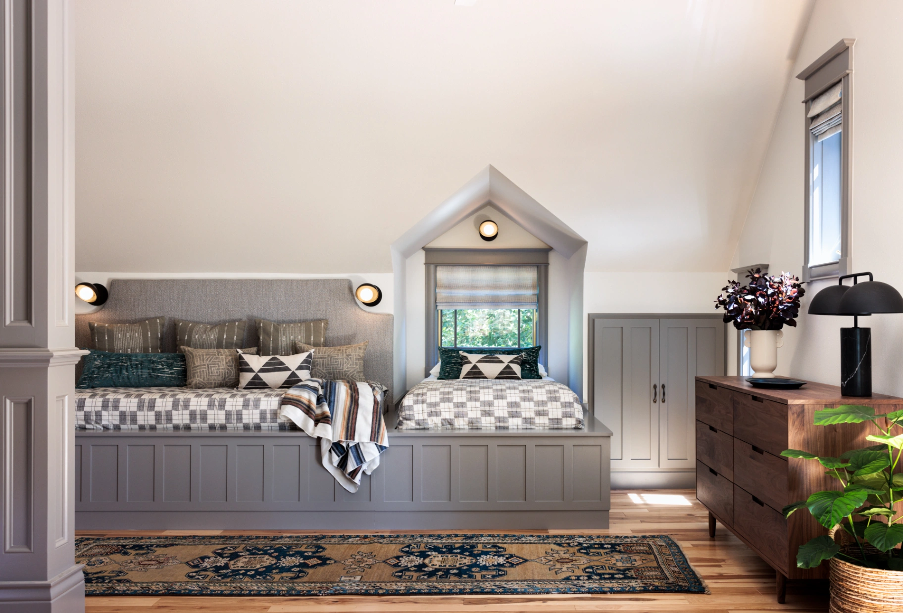 Natural woven Roman shades bringing warmth and texture to a whimsical attic-style children's room