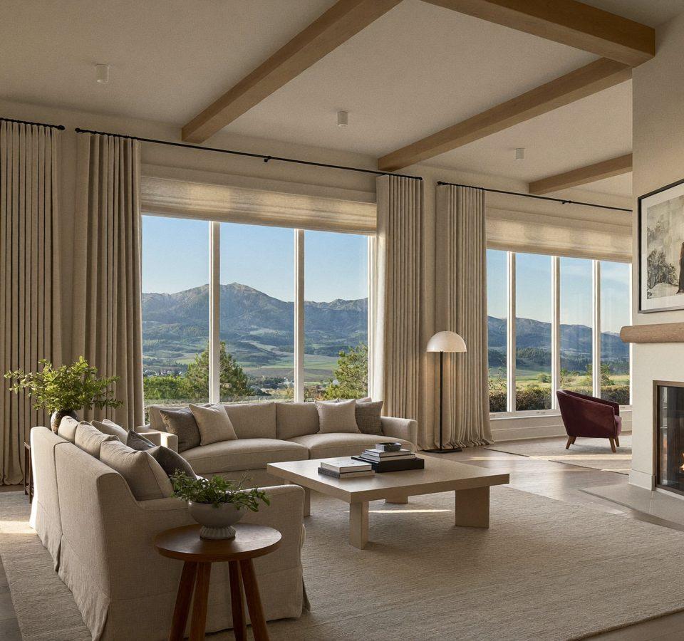 Denver great room with layered linen drapery panels and light-filtering roller shades framing a mountain view
