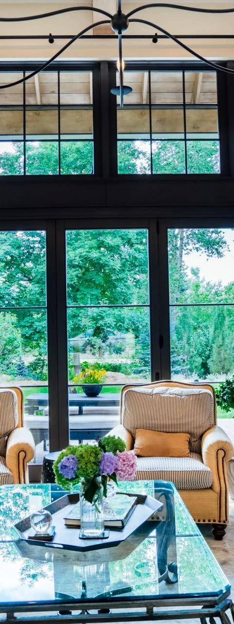 Tall drapery panels frame windows in a bright traditional living room