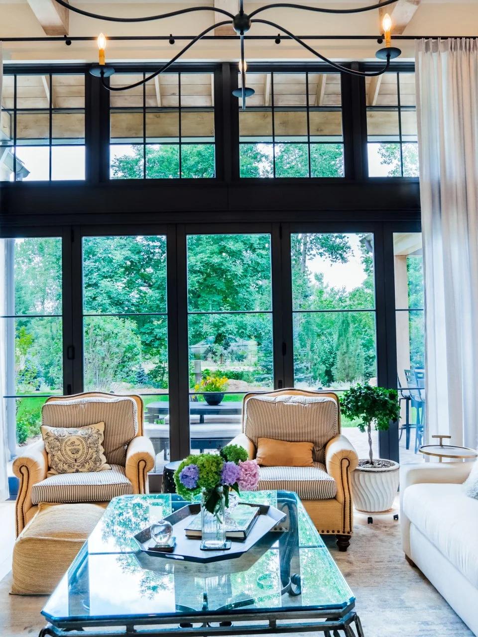 Tall drapery panels frame windows in a bright traditional living room