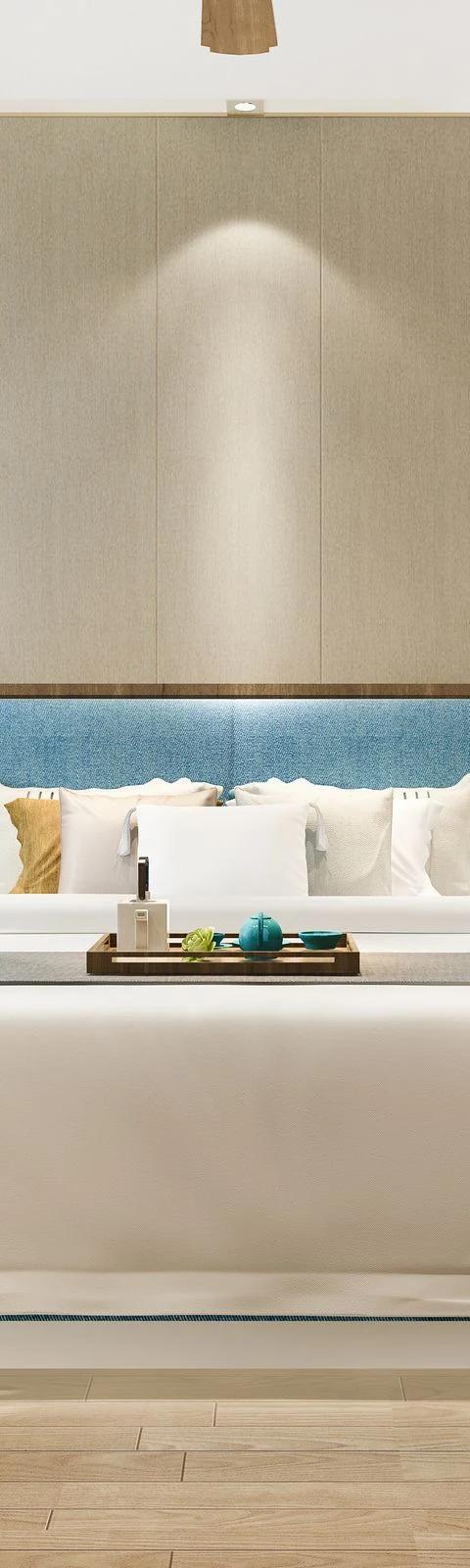 Canopy bed framed by tall drapery panels in a softly lit bedroom