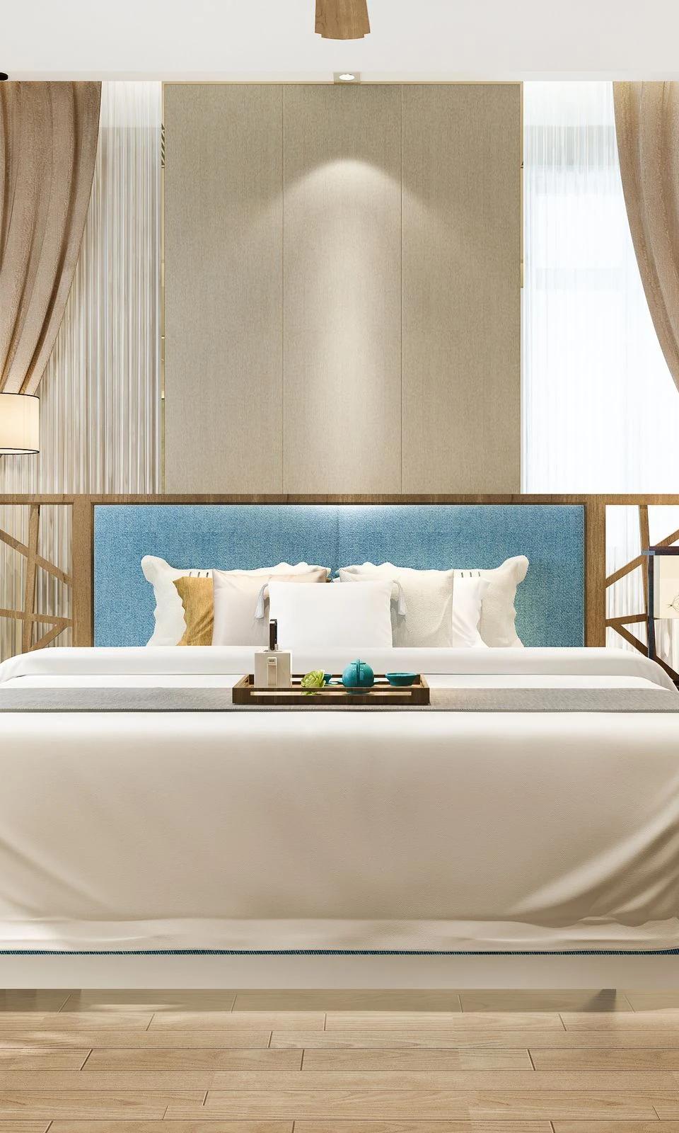 Canopy bed framed by tall drapery panels in a softly lit bedroom