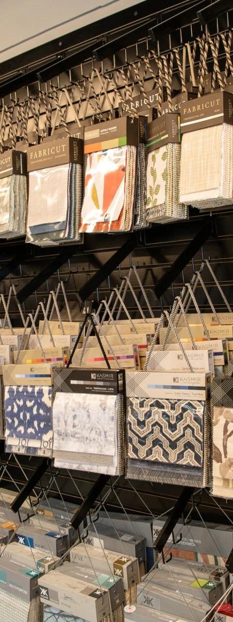 Display wall of fabric swatches and window treatment samples in a showroom