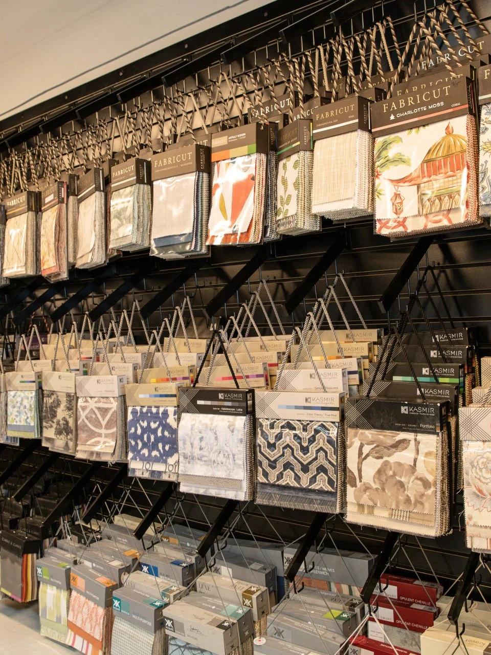 Display wall of fabric swatches and window treatment samples in a showroom