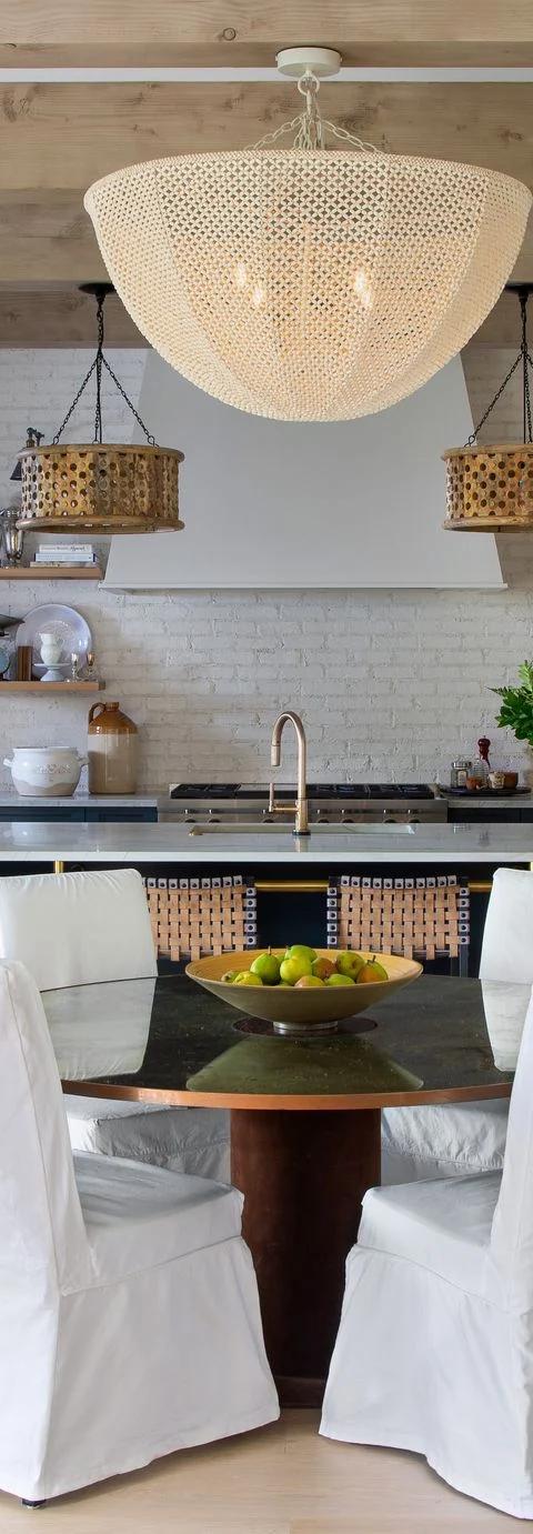 White window treatments soften a bright dining room with exposed ceiling beams