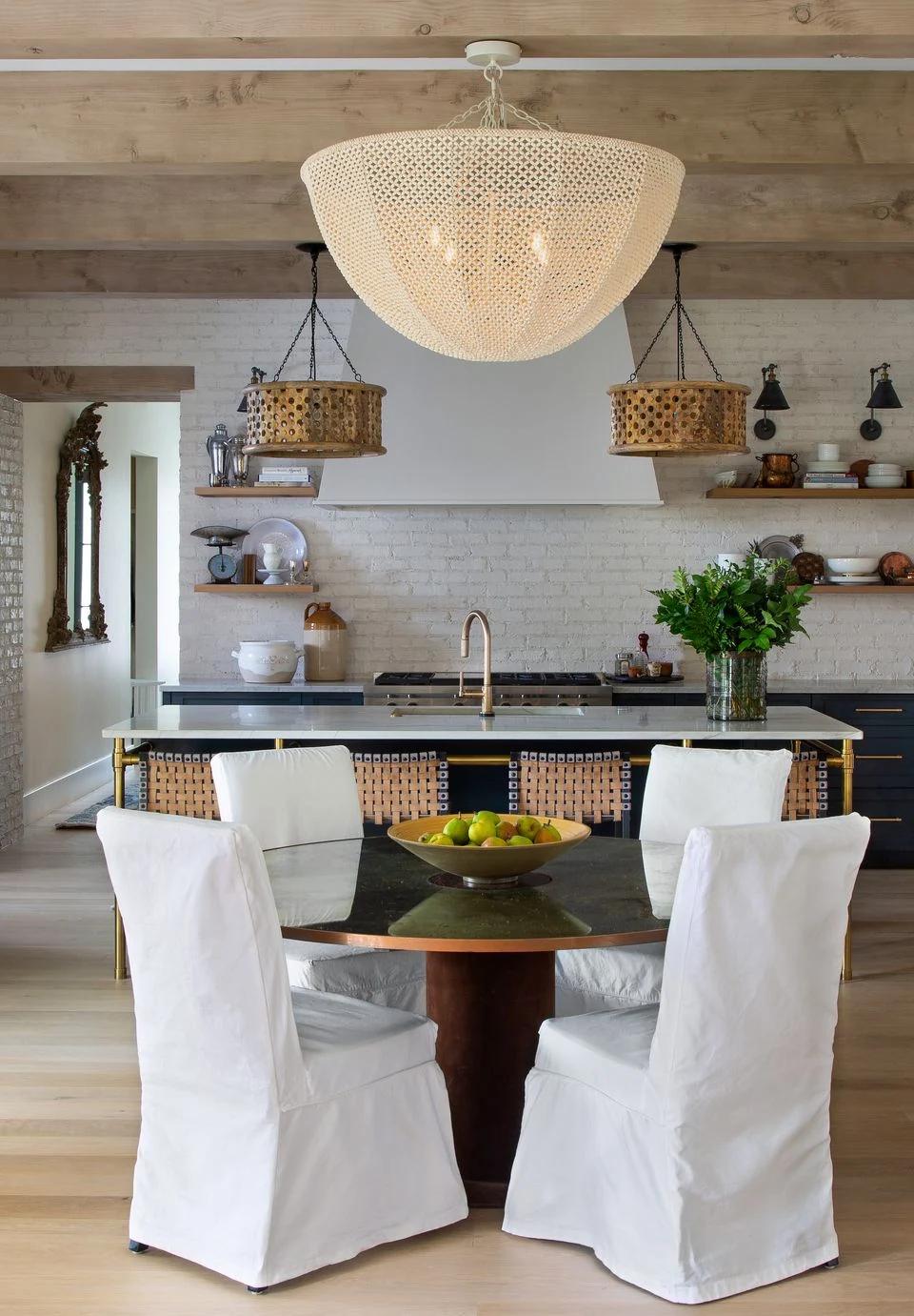 White window treatments soften a bright dining room with exposed ceiling beams