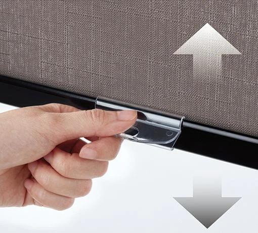 Hand holds a cordless shade handle beneath arrows showing vertical movement